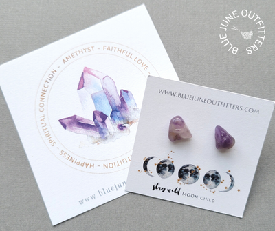 Genuine amethyst gemstone stud earrings. They are organically shaped with hues of dark purple, lavender, white and brown. They arrive thoughtfully packaged on an earring card with our web address and celestial moon phase at the bottom of the card in blue and gold that reads Stay Wild Moon Child. Included as well is a 3x3" watercolor turquoise gemstone card that lists the metaphysical properties - faithful love, intuition, happiness, spiritual connection.