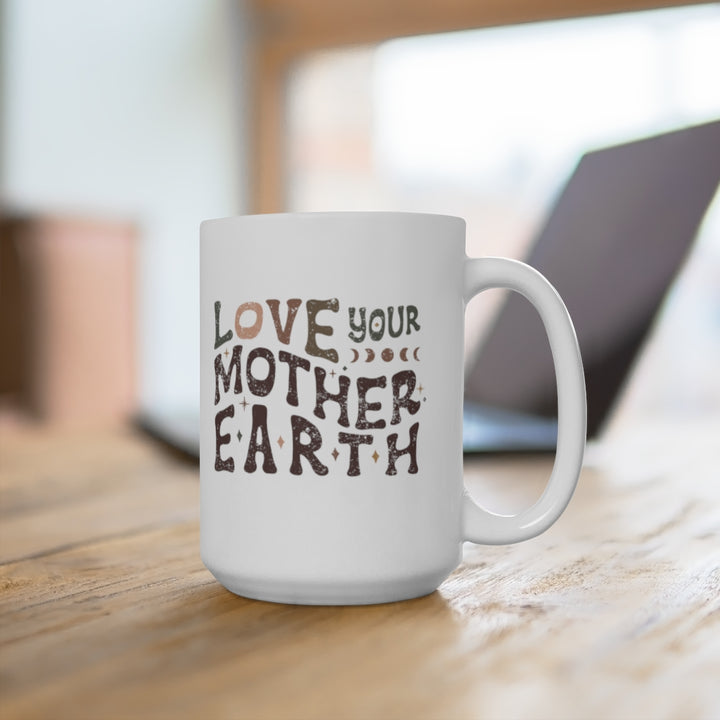 A photo of the mug on a distressed wooden desk next to a laptop to show it in a lifestyle setting. 