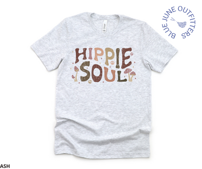 Bella + Canvas Brand unisex tee in ash grey. This shirt is from Blue June Outfitters exclusive Hippie Collection. It features earthy wild mushrooms and small peace signs and reads hippie soul. Hippie Soul in written in a retro wavy font with earth tones. 