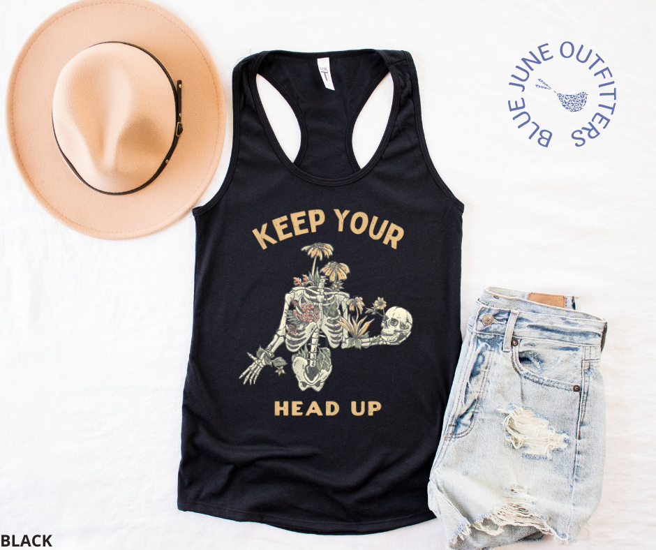 Super soft women's slim racerback tank top in black. This tank is from Blue June Outfitters exclusive Morbid Nature Collection and features a skeleton wrapped in plants and wildflowers holding his on skull up with his hand. The phrase keep your head up is printed. Perfect for those who appreciate dark humor!