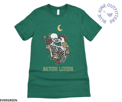 Super soft Bella + Canvas brand tee in evergreen. This shirt from Blue June Outfitters' exclusive Morbid Nature Collection features two skeletons in a loving embrace wrapped in nature under the crescent moon that reads nature lovers at the bottom. This is our take on the lovers tarot card.