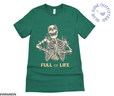Super soft Bella + Canvas brand shirt in evergreen. This tee is from Blue June Outfitters' exclusive Morbid Nature Collection. It features a skeleton covered in plants has the phrase full of life underneath.