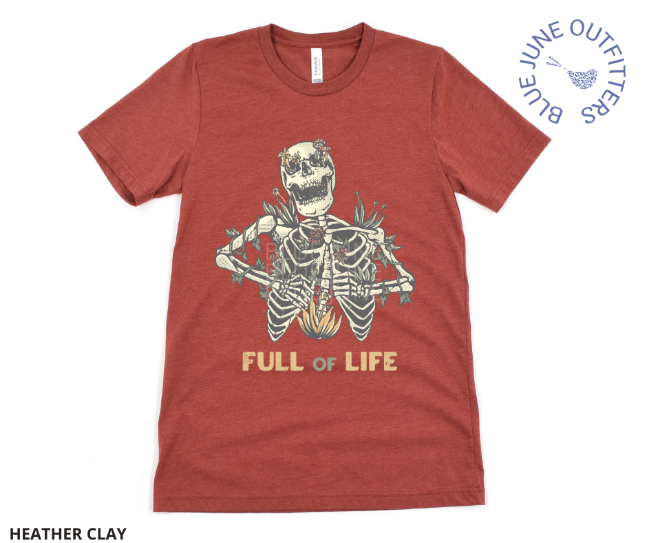 Super soft Bella + Canvas brand shirt in heather clay. This tee is from Blue June Outfitters' exclusive Morbid Nature Collection. It features a skeleton covered in plants has the phrase full of life underneath.