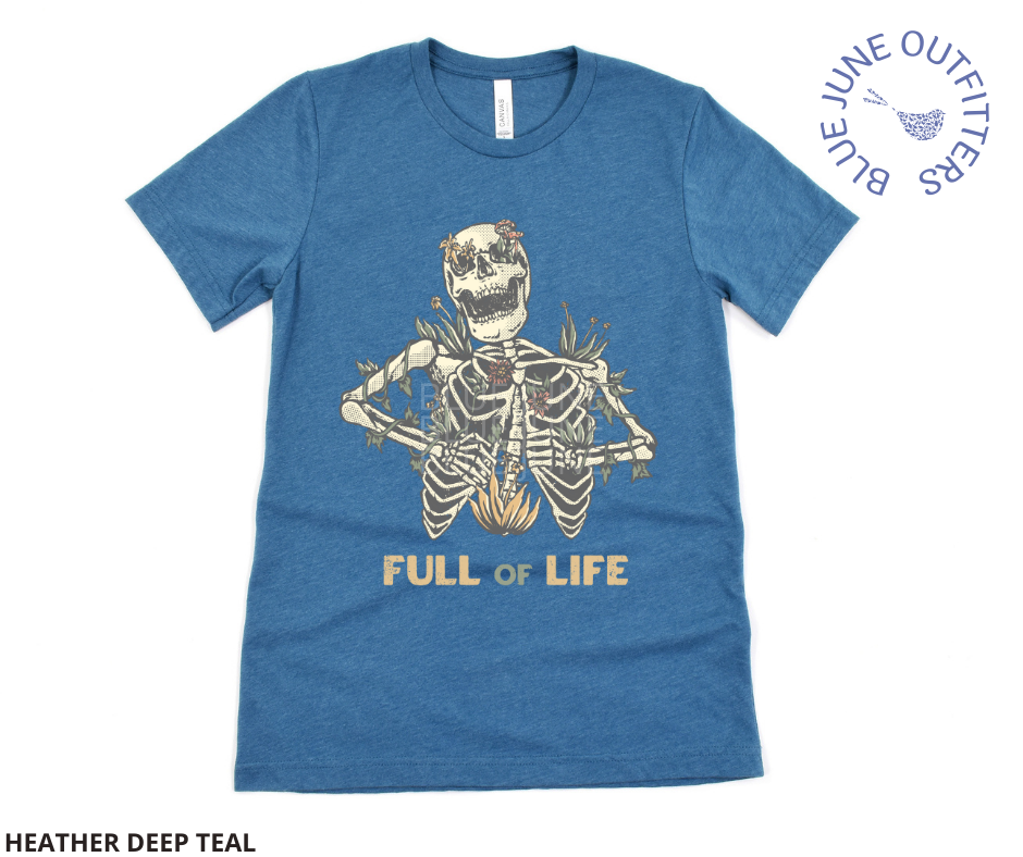 Super soft Bella + Canvas brand shirt in heather deep teal. This tee is from Blue June Outfitters' exclusive Morbid Nature Collection. It features a skeleton covered in plants has the phrase full of life underneath.