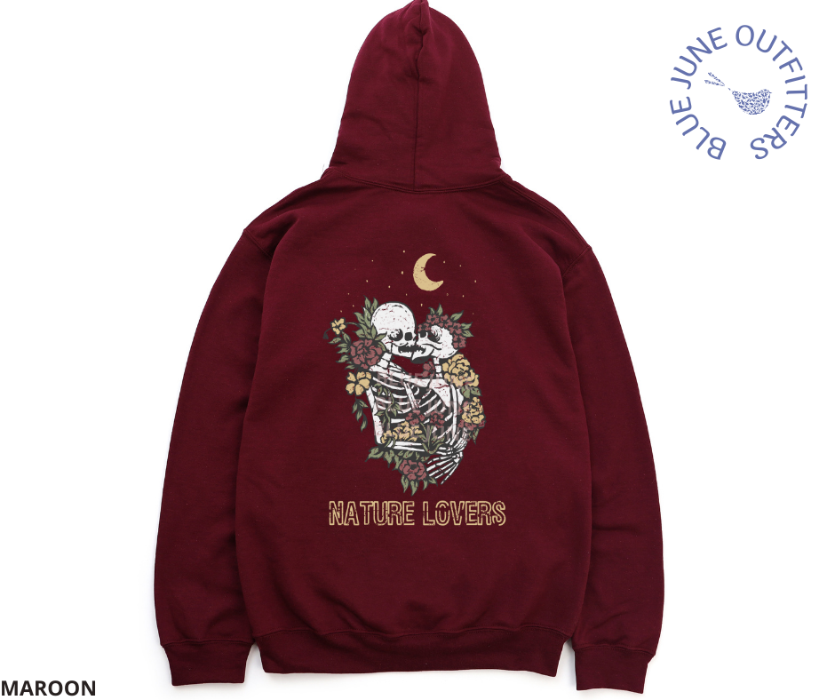 Back view of the maroon hoodie. This is from Blue June Outfitters' exclusive Morbid Nature Collection. It features two skeletons in a loving embrace under the moon and stars, wrapped in plants and wildflowers. It is our take on The Lovers tarot card. The text reads Nature Lovers.