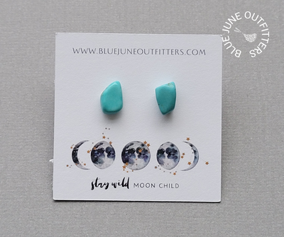 View of another set of turquoise stud earrings on the earring card. This is a closer view. They are a bright blue and this pair has less marbling. 