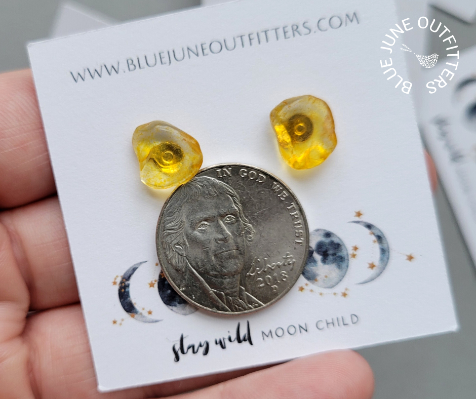 Pair of citrine earrings next to an United States nickel for size reference. Each one is approximately 1/3 the size of a nickel in this photo.