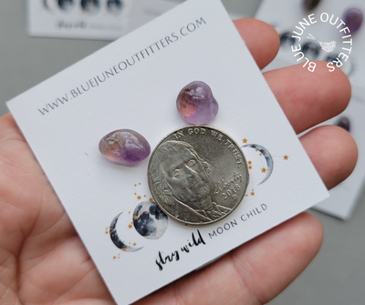 Pair of amethyst earrings next to an United States nickel for size reference. Each one is approximately 1/4 the size of a nickel in this photo.