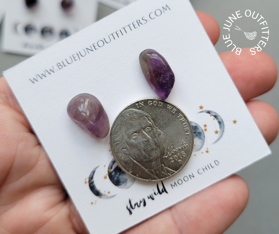 Pair of amethyst earrings next to an United States nickel for size reference. Each one is approximately 1/3 the size of a nickel in this photo.