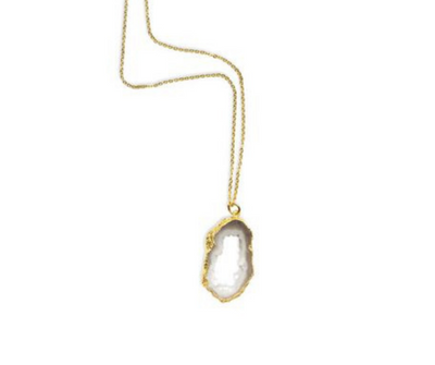 The agate slize druzy necklace against a plain white background with a longer view of the chain. 