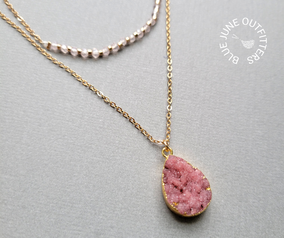 close view of the light pink glass crystals and the electroplated mauve druzy pendant. 