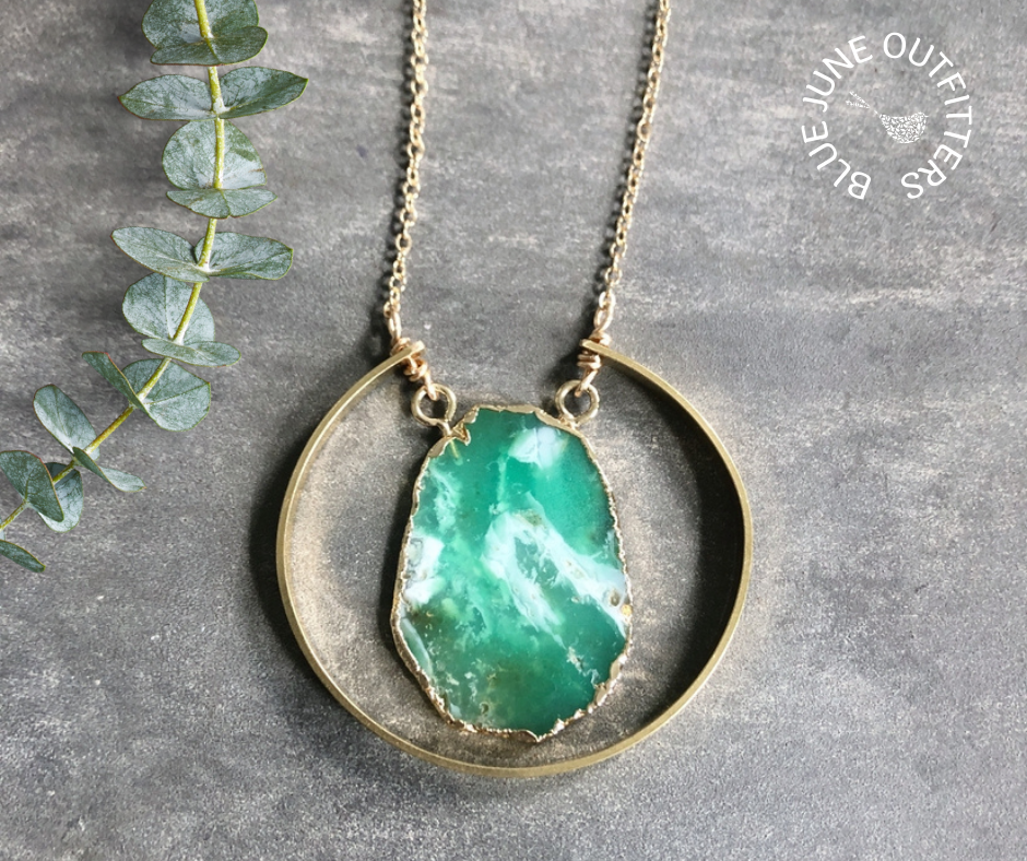 Beautiful green raw chrysoprase slice pendant surrounded by gold electroplating.  It is encompassed by a brass semi-circle accent.  The chain is 30" with a 2" extender and is hypo allergenic gold plated.  