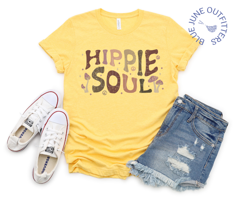 Bella + Canvas Brand unisex tee in yellow. This shirt is from Blue June Outfitters exclusive Hippie Collection. It features earthy wild mushrooms and small peace signs and reads hippie soul. Hippie Soul in written in a retro wavy font with earth tones. Paired here with jean shorts and white converse shoes.
