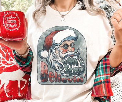 Don't Stop Believin' | Comfort Colors® Groovy Santa Christmas Tee
