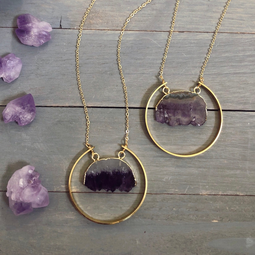 View of two raw amethyst necklaces side by side to display the variations in each stone. 